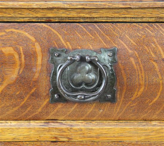 An Arts & Crafts carved oak sideboard with raised mirrored back, W. 5ft 8in. D. 1ft 11in. H. 6ft 4in.